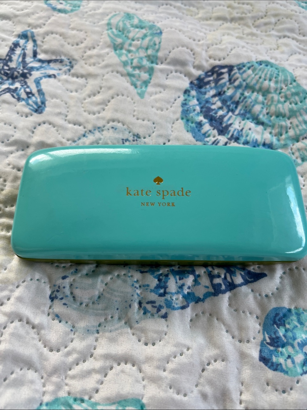 kate spade turquoise hard-shell eyewear case with gold logo